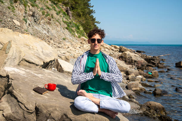 istock A young attractive guy is resting by the sea. 2168061449