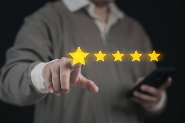 istock Businessman Selecting Five Star Satisfaction Rate on Virtual Screen on Mobile App for Positive Feedback : Modern Success in Digital Communication or Complacent Achieving Excellence in User Experience 2168062747