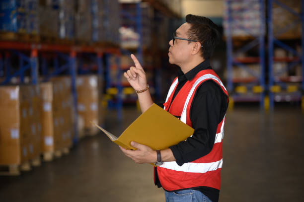 istock Warehouse worker working in warehouse storage. Foreman or worker work at factory site check up products in site. Inventory worker working in factory Storehouse 2168069352