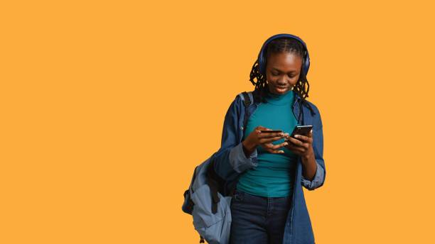 istock Girl wearing headphones adding payment method on website, studio background 2168069961