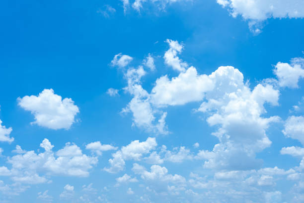 istock Fluffy white clouds drift across a bright blue sky, painting a beautiful summer day 2168071818