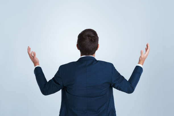 istock Back, confused and why with business man in studio on white background for solution or question. Arms raised, corporate and problem solving with employee asking for answer in suit on mockup space 2168071885