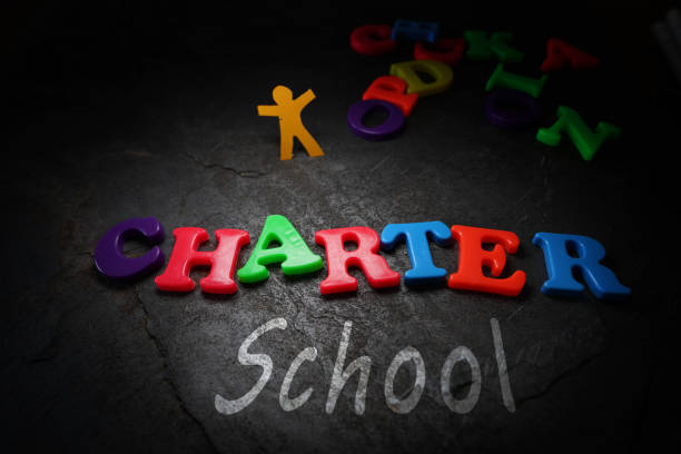 istock Charter School letters with paper child cutout 2168071944