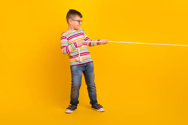 istock Full profile side photo of sweet kid boy playing outdoors pull string isolated on vibrant color background 2168073616