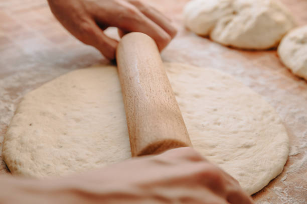 istock Rolling Dough with Wooden Rolling Pin for Baking 2168074785