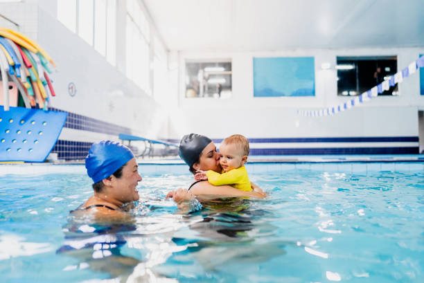 istock Mother playing with son during swimming pool lessons 2168080105
