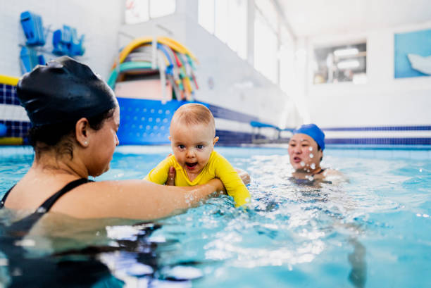 istock Mother playing with son during swimming pool lessons 2168080119