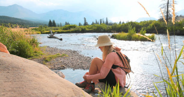 Mature woman explores river in mountains