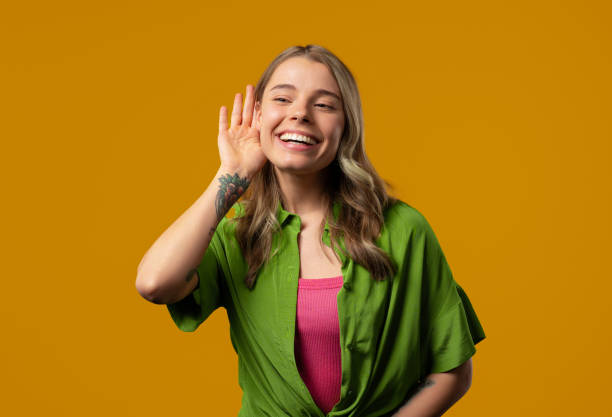 istock Curious blonde woman doesn't hear. Whisper quiet sound, deaf, misunderstand 2168081269