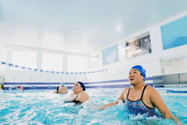 istock Mature women training at swimming pool 2168081497