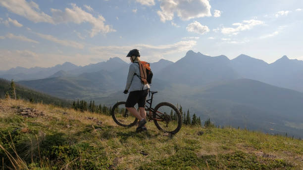 istock Mountain biker on summit above valley and mountains 2168081708