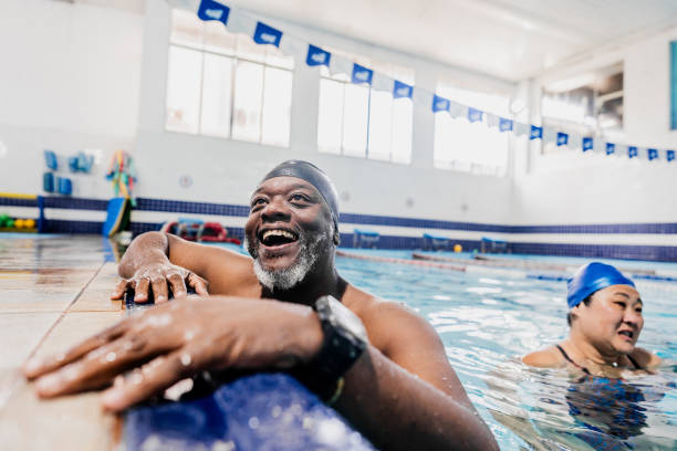 istock Mature man talking with instructor at swimming pool 2168083037