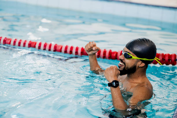 istock Young man celebrating at swimming pool 2168083150