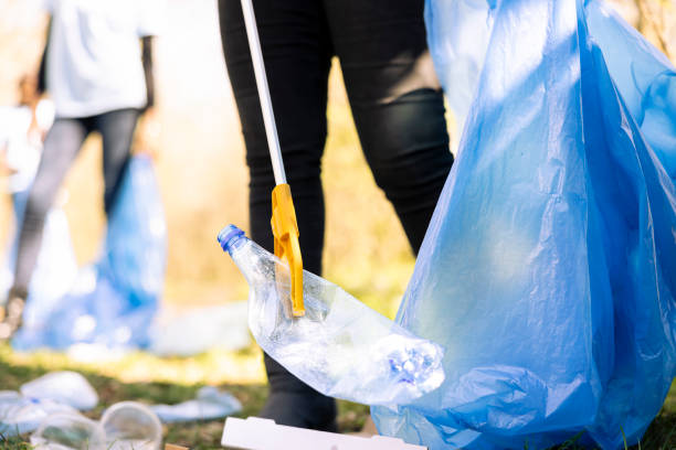 istock Female environmentalist picking up garbage from the ground to fight pollution 2168085657