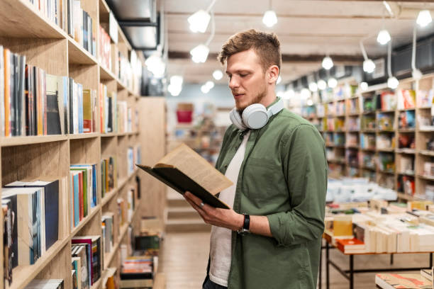 istock Smiling Student in Library with Headphones and Book 2168090153