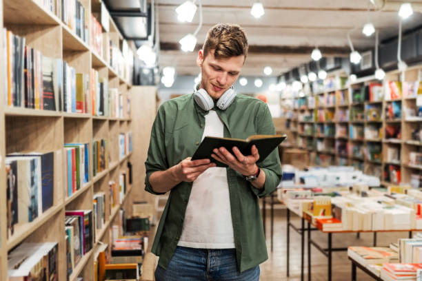 Caucasian Student Smiling with Headphones and Open Book