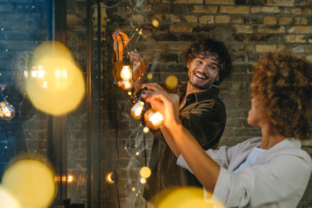 istock Young man and woman looking at each other while hanging garland 2168094246