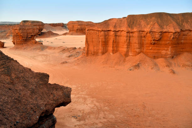 Tômbua (Porto Alexandre), Namibe Province, Angola: Colinas Canyon, a red sandstone canyon on the Curoca river estuary - rock formations sculpted by water and wind erosion over the eons - a striking natural feature characterized by its steep cliffs, rugged terrain, and dramatic rock formations. The canyon is part of the country's diverse landscape, showcasing the raw beauty of Angola's natural environment. Its deep valleys and winding paths offer a serene yet imposing atmosphere, making it a notable destination for those interested in geology, hiking, and photography