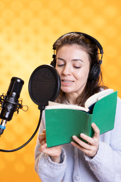 istock Cheerful person recording audiobook, isolated over studio background 2168096293