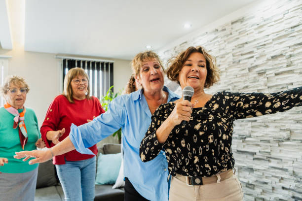 istock Friends having fun singing karaoke at home 2168099688