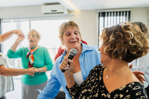 istock Friends having fun singing karaoke at home 2168099707