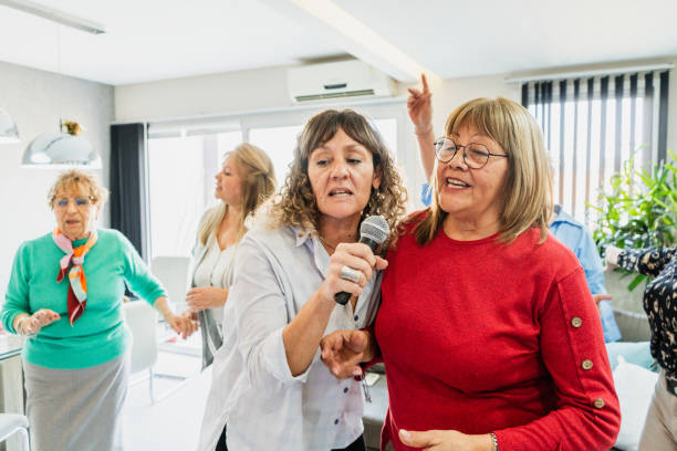 istock Female friends singing on karaoke at home 2168100288