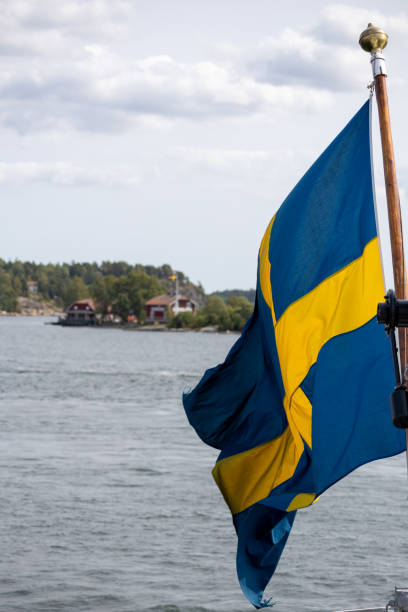 istock Swedish Flag Over Scenic Lake 2168103105