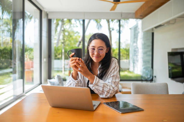 istock Asian Woman Enjoying Coffee During Remote Work 2168105222