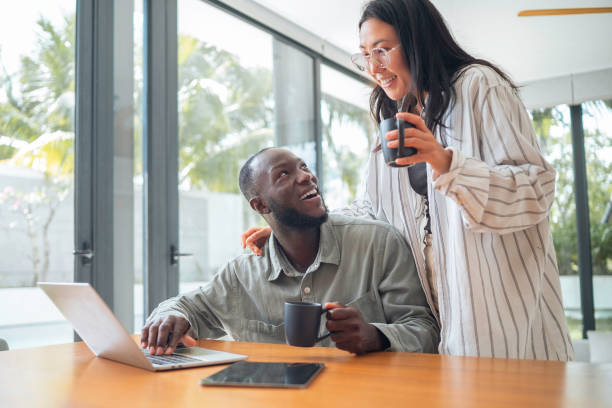 istock Asian Woman and Black Man Collaborating Remotely 2168105239