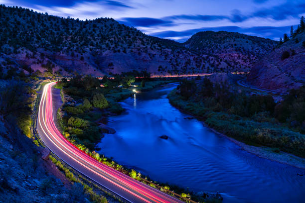 istock Driving at Night Along River Time Exposure with Light Trails 2168106205