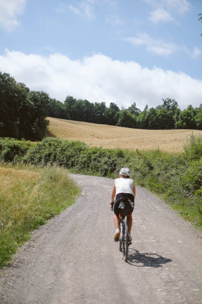 istock Young woman bicycles through rural landscape 2168108023