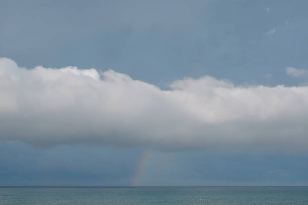 Sea and rainbow in cloud above, Tuscany, bike packing from Marina di Grosetto to Castiglione della Pescaia