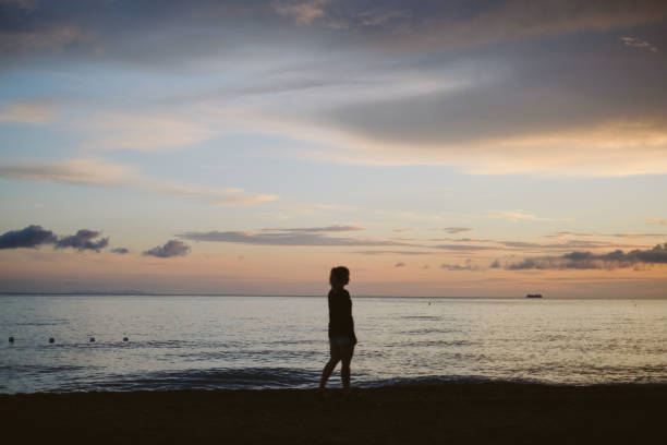 istock Young woman on beach at sunset, Tuscany 2168110451