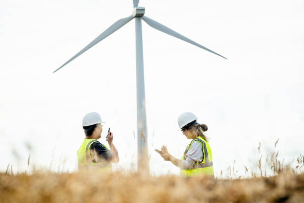 istock Technicians Working On Wind Farm With Turbines In Background 2168110827