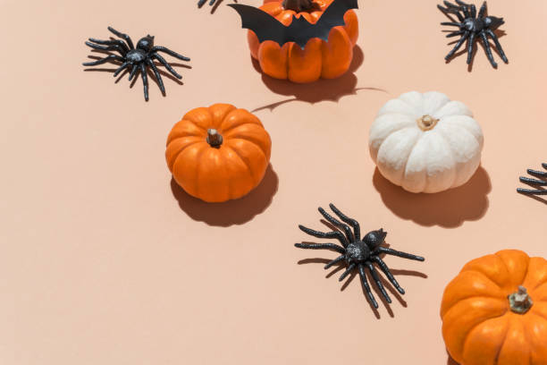 istock Halloween banner pumpkin pattern with trendy hard shadows. Orange pumpkins and black spiders pattern on pastel background. Decoration for Halloween party. Copy space, blogs, promotions. 2168111695