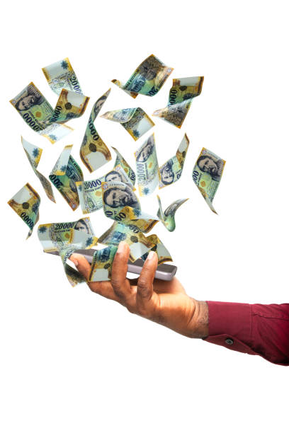 istock Black hand holding phone with  Hungarian Forint  notes hovering on screen isolated on White background. Hungary currency 2168115296