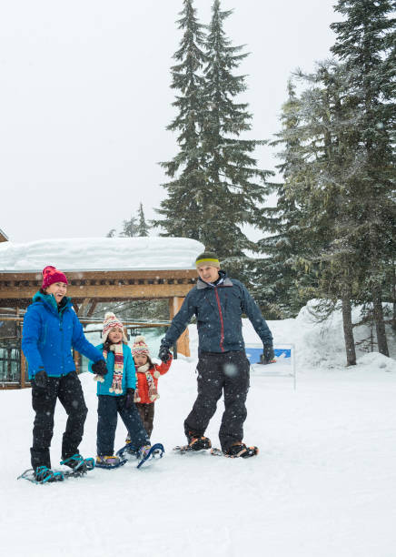 istock Family snowshoes into forest 2168116671