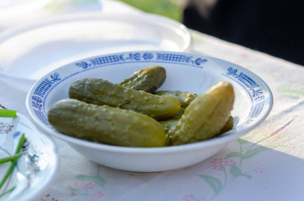 istock A white bowl filled with homemade pickled cucumbers sits on a tablecloth. 2168116906