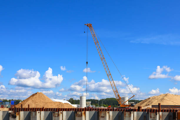 istock Mobile Crane on a road and tower crane in construction site 2168120369