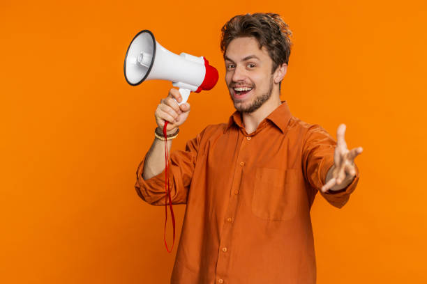 istock Caucasian man talking with megaphone proclaiming news loudly announcing advertisement discounts sale 2168120818