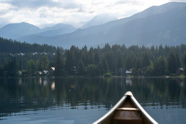 View past canoe bow to lake and mountains, Alta Lake, Whistler, B.C.