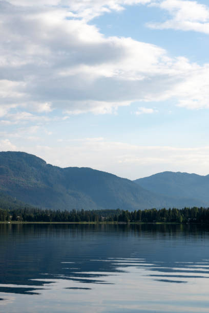 Reflection of mountains in lake and lofty clouds, Alta Lake, Whistler, B.C.