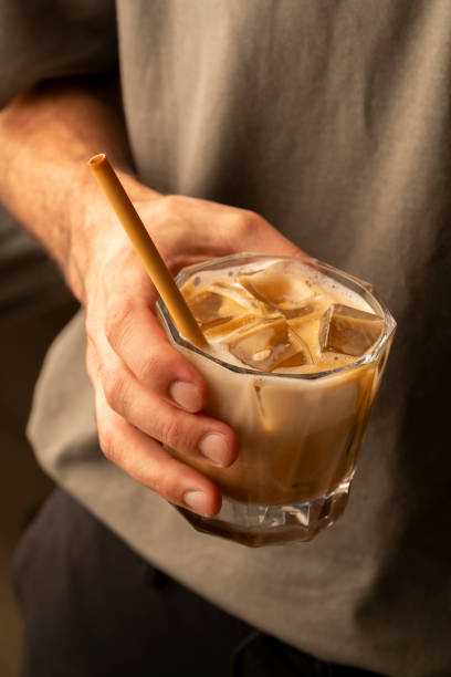 istock barista man serves iced latte coffee 2168125952