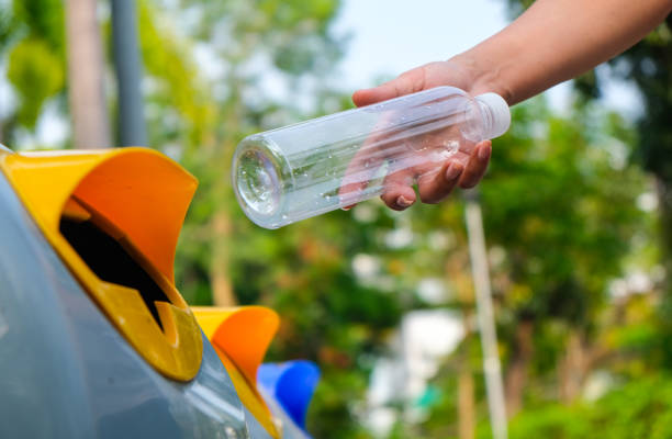 istock Please throw plastic bottles in the bin. Man littering the bins by separating waste for disposal such as recyclable plastic waste. environmental concept 2168131808