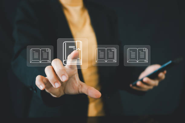 istock E-library concept. Person use laptop with virtual E-book icons for electronic books online, knowledge base on internet, digital library or e-library. 2168141019
