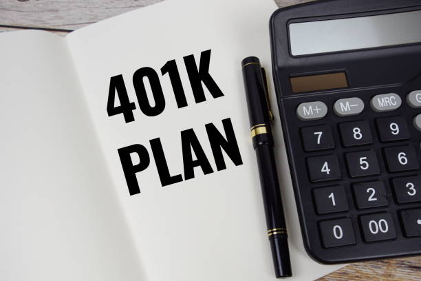 istock 401K Plan text message written on note page with calculator top view on wooden background 2168145383