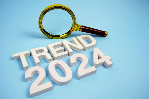istock Trend 2024 word with magnifying glass top view on blue background 2168145544