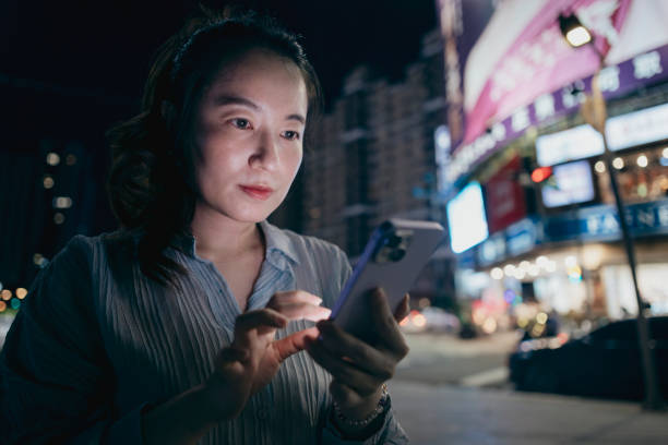 istock Young businesswoman using smartphone in street 2168148249