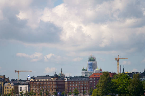 Helsinki, Finland. June 29, 2024 - Cloudy sky over skyline with Helsinki cathedral under renovation