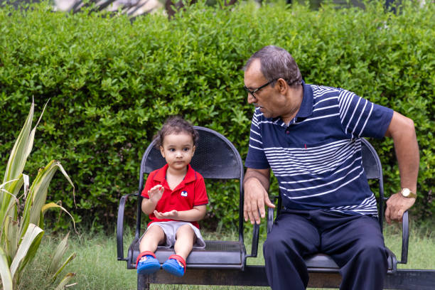 istock isolated man spending quality time with grandson at outdoor park at evening from flat angle 2168148550